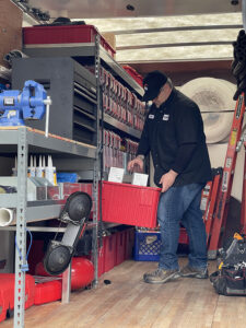 technician-getting-tools-from-back-of-service-truck